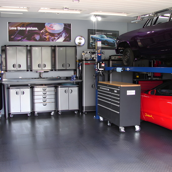 Organized garage with car lift, cabinets, and tool chests - John from Saskatchewan, Canada