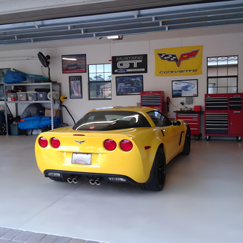 Organized garage with yellow Corvette and tool cabinets - Jack from Viera, FL
