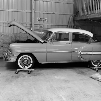 Classic car on wheel dollies in organized garage - Dan from Allison Park, PA