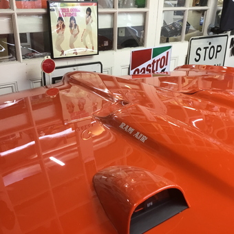 Orange Muscle Car Hood with Vintage Garage Signs - GM from Rye Brook, NY