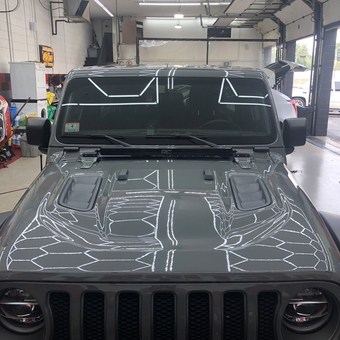 Modern garage with Jeep and overhead lighting - The Godfather from Peabody, MA