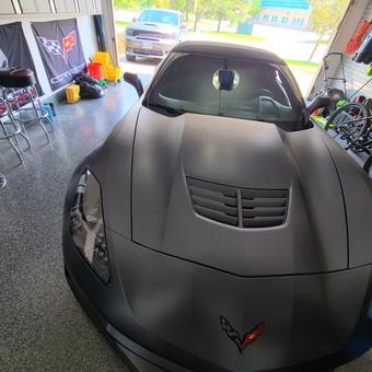 Corvette Garage With Cabinets, Bar Stools, and Wall Decor - Angelo