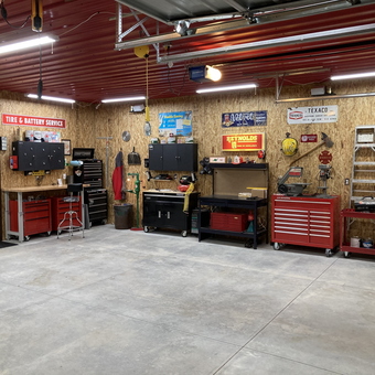 Organized garage with tool cabinets, workbenches, wall storage - Wag from Larned, KS