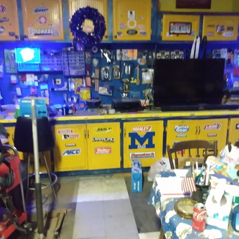 Organized garage workspace with yellow cabinets and tools - Quicktoy from Comklin, MI