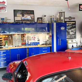 Organized Garage with Blue Cabinets and Wall Tire Rack - William from Va Beach