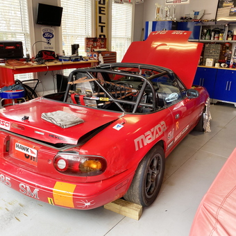 Red race car, tool cabinets, and workbench in garage - William from Va Beach