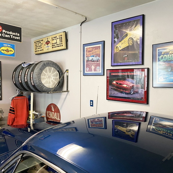 Garage With Racing Signs, Tire Rack, and Car Posters - William from Va Beach