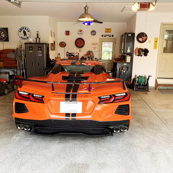 Organized garage with Corvette, cabinets, and decor - Neon Leon from Canal Winchester