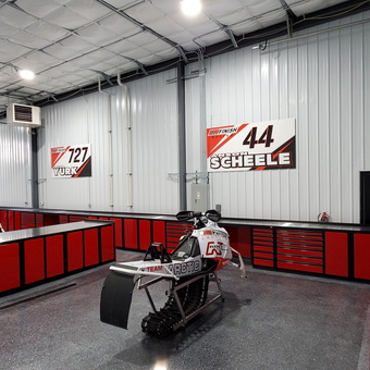 Red Garage Cabinets and Snowmobiles in Racing Workshop - All Finish Racing