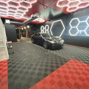Modern garage with LED hex lights and tile flooring - Redlevel Carwash and Detailing