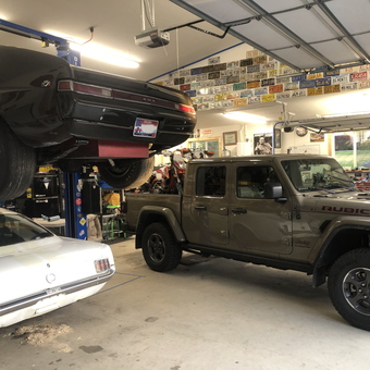 Classic Car Garage with Lift and License Plate Decor - Chris from Hauser, ID