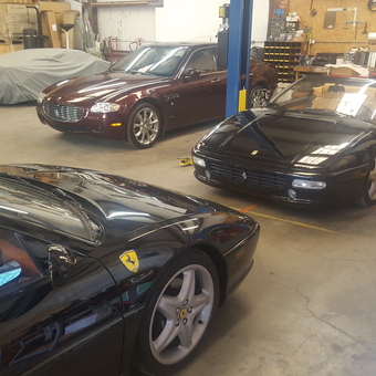 Luxury cars, lifts, and workbenches in organized garage - TBSHOPCARS from Roswell, NM
