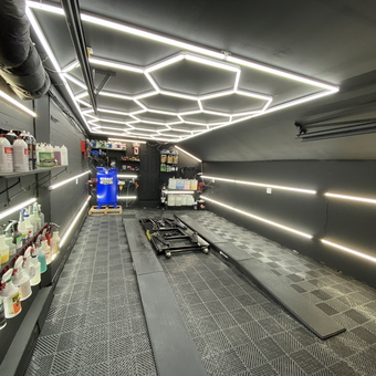 Modern garage with LED lighting, car lift, and storage - Fast Freddy from Ballston Spa
