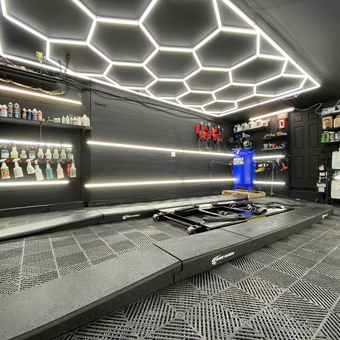 Modern garage with LED lights, car lift, and storage - Fast Freddy from Ballston Spa