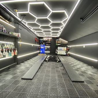 Modern garage with LED lighting, floor tiles, wall racks - Fast Freddy from Ballston Spa
