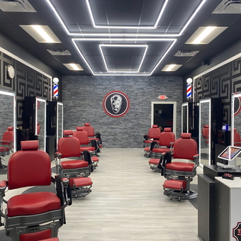 Modern Barbershop with Red Chairs and LED Mirrors - The Hairy Bastard Barbershop in Fort Lauderdale