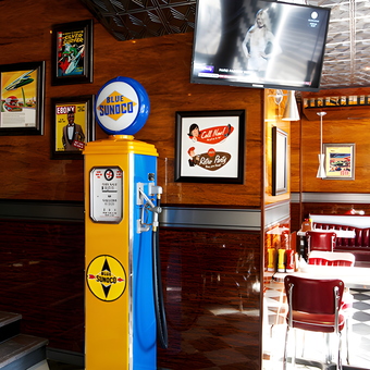Retro diner with vintage gas pump and wall art - Retro Diner