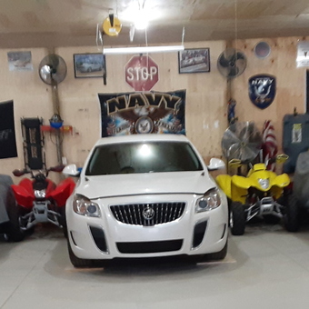 Garage with Covered Cars, Wall Signs, and ATVs - Greg from Coopersville, MI
