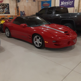 Garage with Red Sports Car and Wall Banners - Greg from Coopersville, MI