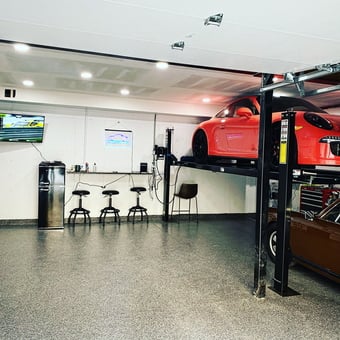 Modern garage with car lift, bar stools, and TV - Brian from Cincinnati, OH