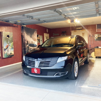 Organized garage with wall art, workbench, and Lincoln SUV - Bruce from Oklahoma City, OK