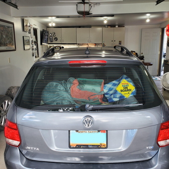 Organized Garage With VW Jetta, Cabinets, and Wall Decor - ci-27729