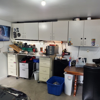 Garage with Wall Cabinets, Workbench, and TV - ci-27730