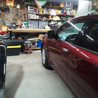 Organized garage with workbench, tools, and car - Rick from Goshen, CT