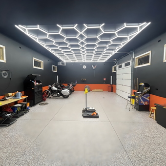 Modern garage with LED lighting, tool cabinets, and motorcycles - Mike