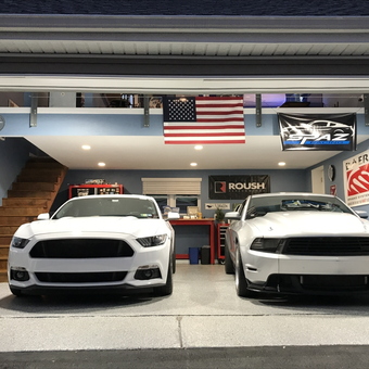 Organized garage with two Mustangs and car banners - Spaz from Bensalem PA