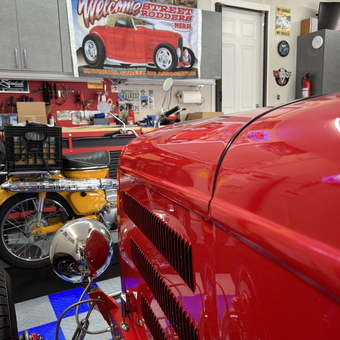 Classic car garage with neon signs and wall art - Dave