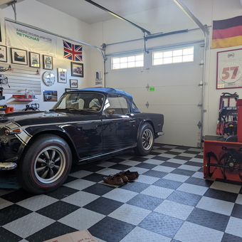 Classic Car Garage with Checkered Floor and Wall Storage - Rich