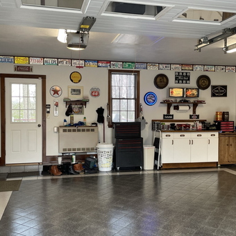 Organized garage with vintage signs and tool cabinets - Joanie