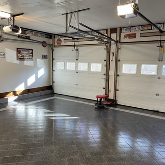 Clean garage with tile flooring and decor - Joanie