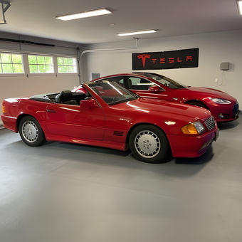 Organized Garage With Red Cars and Tesla Banner - Vince from Peconic, NY