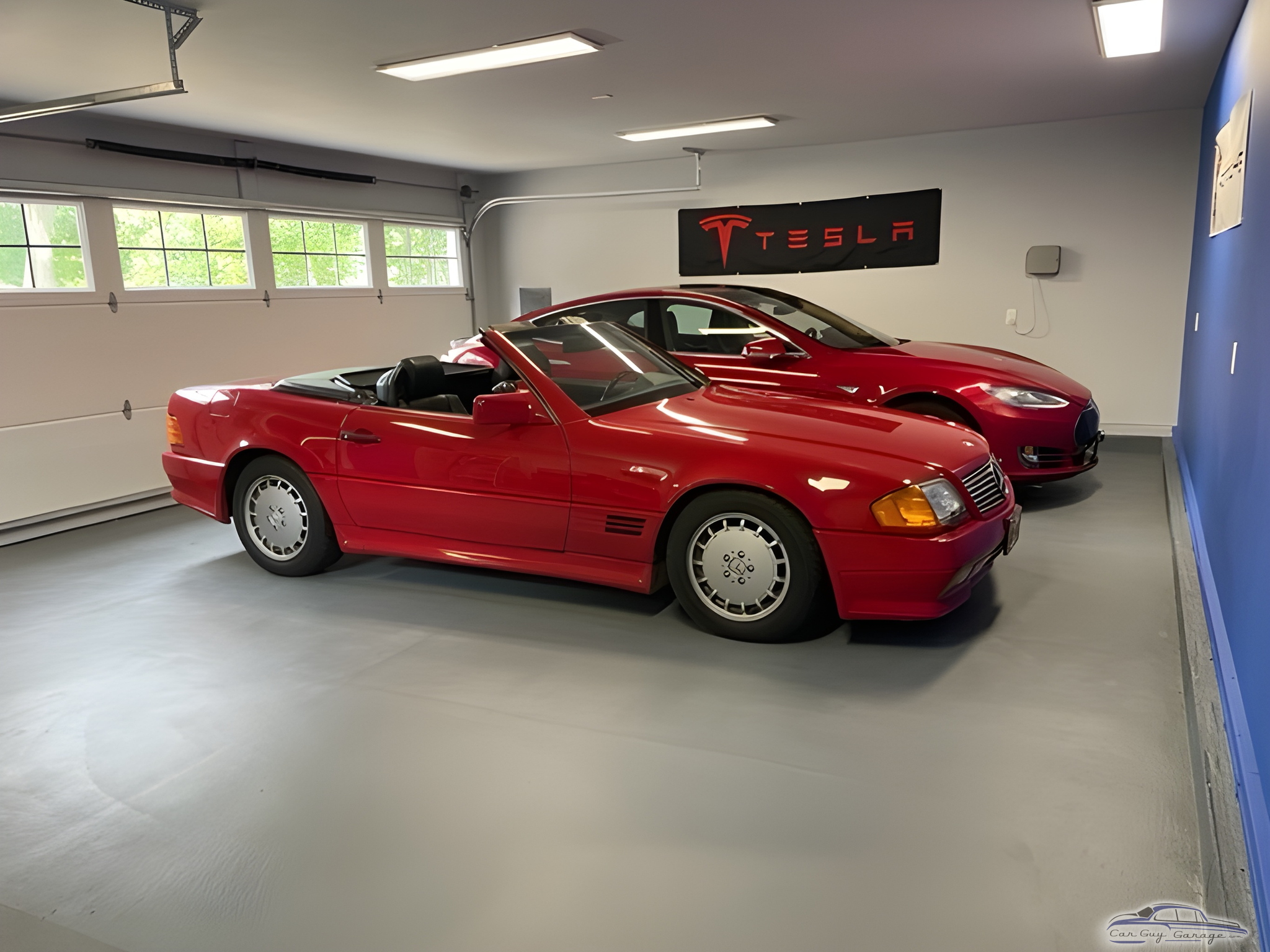 Organized Garage With Red Cars and Tesla Banner - Vince from Peconic, NY