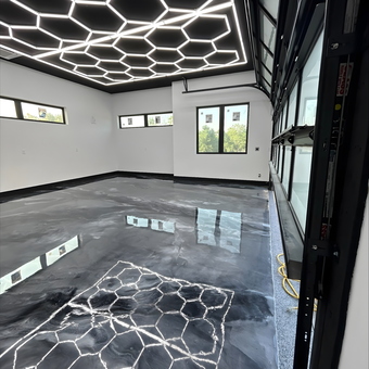Modern garage with hexagon LED lights and epoxy floor - Kevin