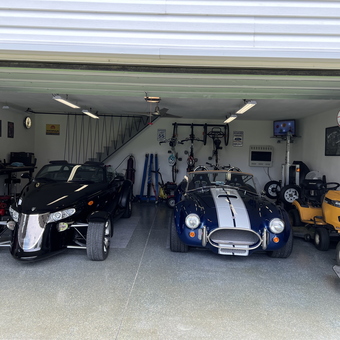 Organized garage with classic cars, mowers, and wall storage - Gary Hawkinson from Marion, IA