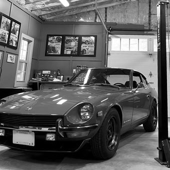 Classic car in organized garage with lift and wall art - Gab from Petawawa Ontario