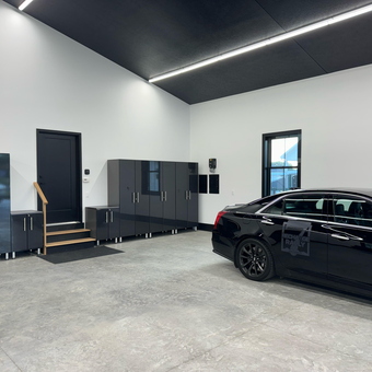 Modern Garage with Sleek Cabinets and Black Car - Art