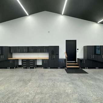 Modern Garage with Black Cabinets and Workbench - Art