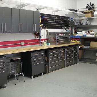 Modern garage with cabinets, workbench, and storage - Page from Goleta, CA