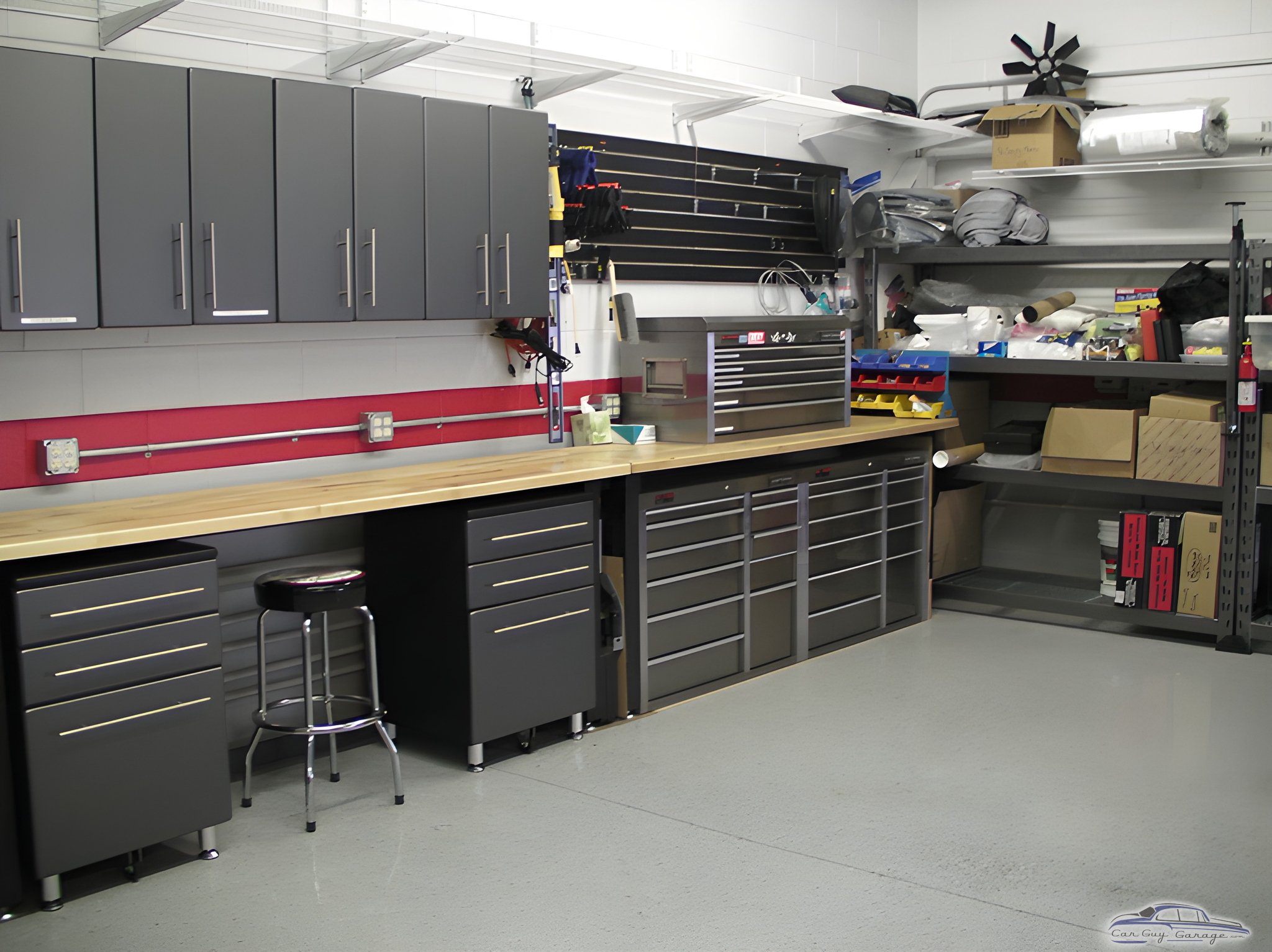 Modern garage with cabinets, workbench, and storage - Page from Goleta, CA