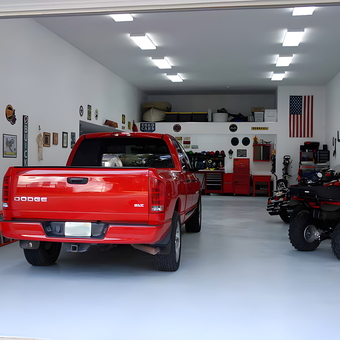 Organized garage with red truck, ATVs, and tool cabinets - David from Tallahassee, FL