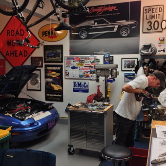 Organized garage with car, tools, and wall signs - Max Torque from Wauconda, IL
