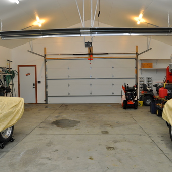Organized garage with covered cars and storage shelves - Champ from Grand Meadow, MN