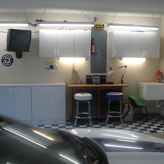 Organized garage with cabinets, stools, and utility sink - Kip from Beverly Hills, FL