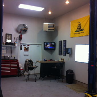 Organized garage with tool chest, car lift, and workspace - John from Andover, MN
