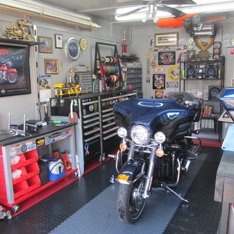 Organized garage with motorcycle, tool chests, and wall decor - Wayne from Gainesville, TX