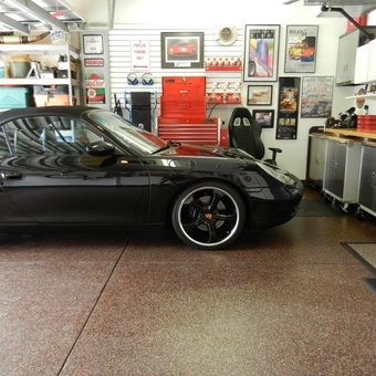 Organized garage with Porsche, tool cabinets, and wall art - Wayne from Bradenton, FL